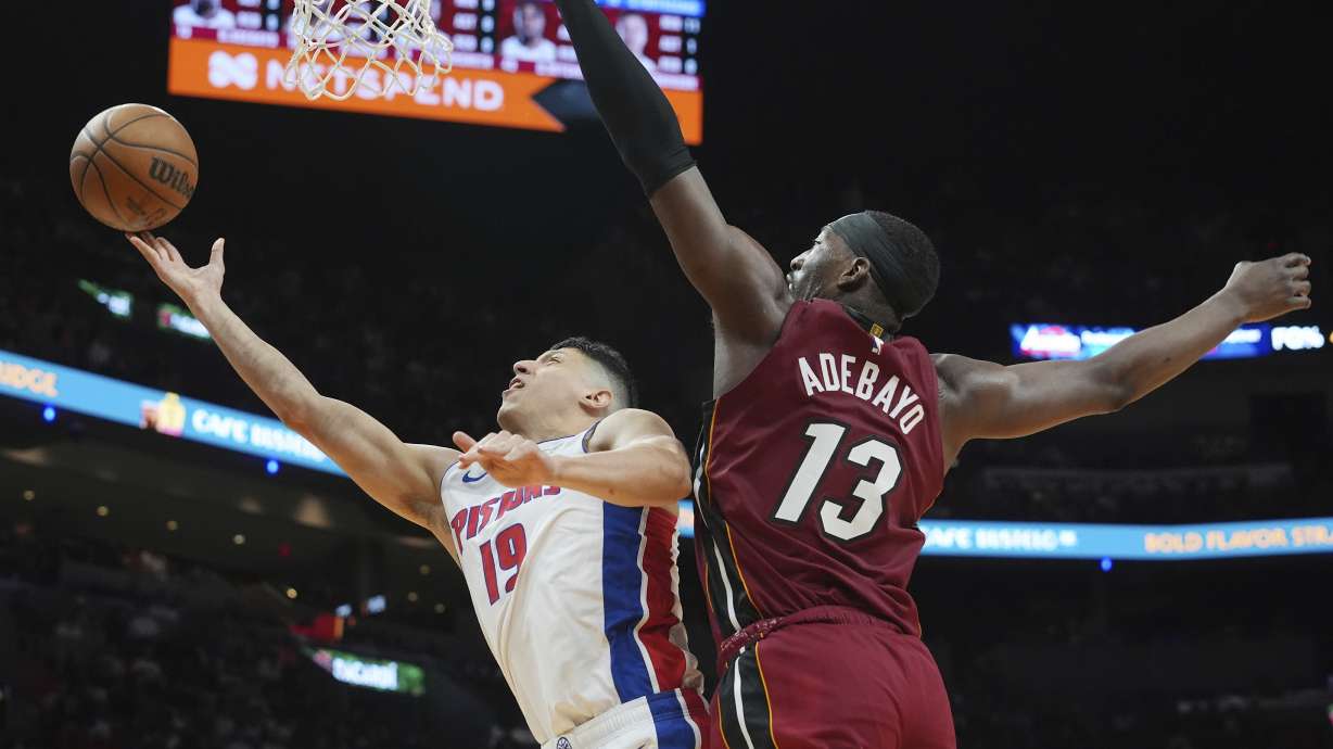 Detroit Pistons forward Simone Fontecchio (19) drives to the basket as Miami Heat center Bam Adebayo (13) defends during the first half of an NBA basketball game, Wednesday, March 19, 2025, in Miami.