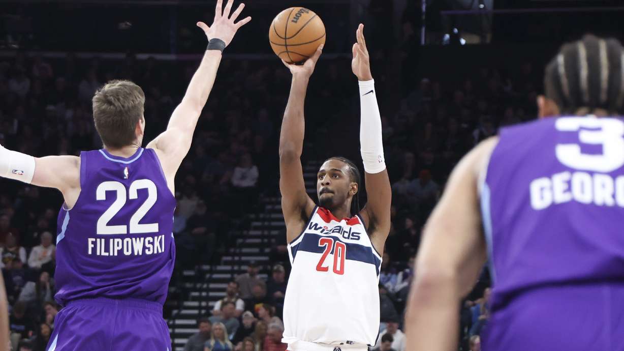 Washington Wizards forward Alex Sarr (20) shoots over Utah Jazz forward Kyle Filipowski (22) during the first half of an NBA basketball game, Wednesday, March 19, 2025, in Salt Lake City.