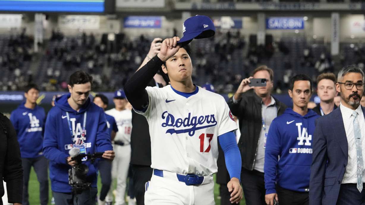 Los Angeles Dodgers' Shohei Ohtani waves to fans as he walks off the field after the team's MLB Tokyo Series baseball game against the Chicago Cubs in Tokyo, Japan, Wednesday, March 19, 2025.