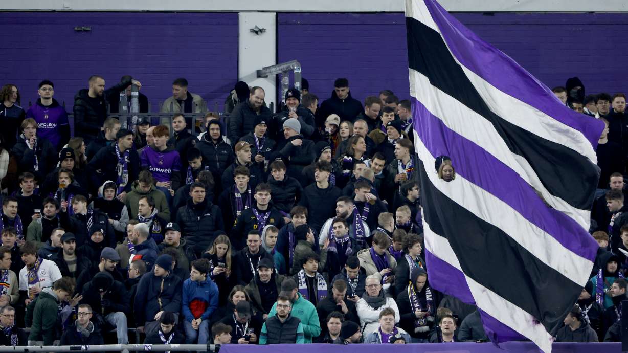 Anderlecht fans wave a flag in the stands prior to the Europa League playoff second leg soccer match between Anderlecht and Fenerbahce at the RSC Anderlecht stadium in Brussels, Thursday, Feb. 20, 2025.