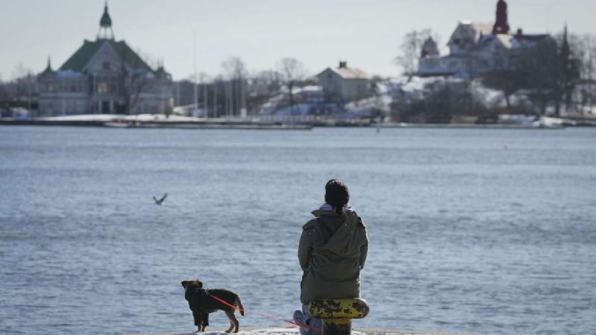 A woman enjoys a sunny and frosty day on the embankment of the South Harbour in Helsinki, Finland, March 15. The northern European country is leading the world in happiness for the eighth year in a row.