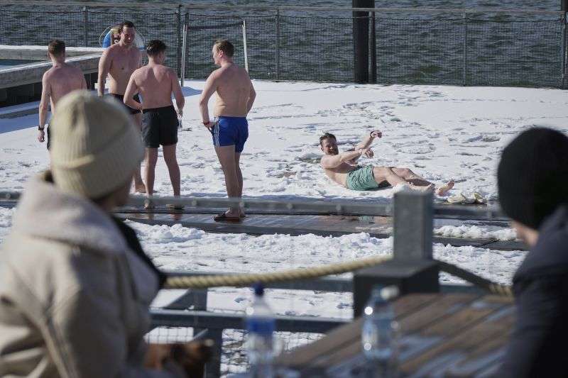 People enjoy a sunny and frosty day after sweating in the sauna of the public bath in Helsinki, Finland, March 15.