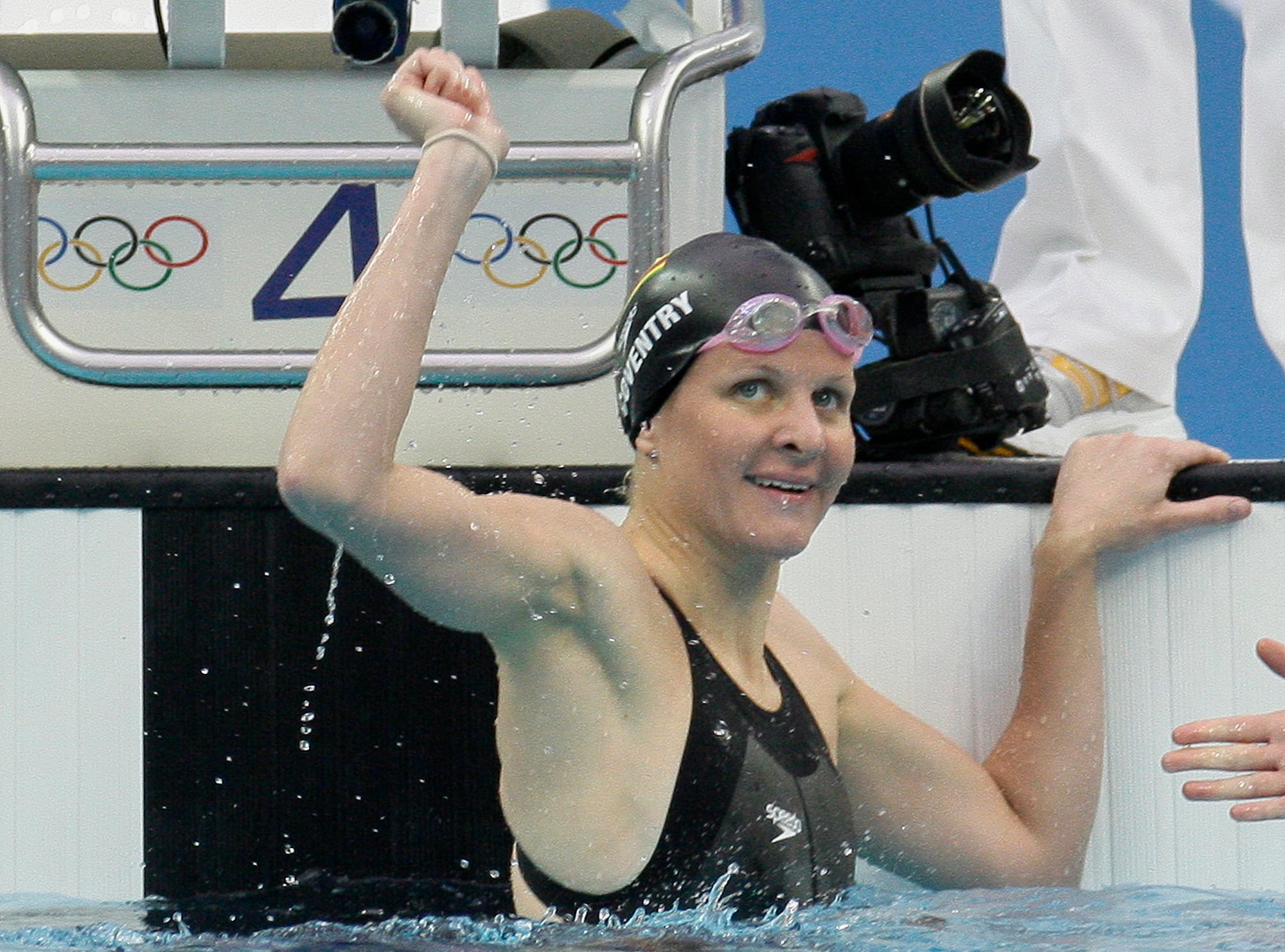 Zimbabwe's Kirsty Coventry reacts after setting a new world record in the women's 100-meter backstroke semifinals during the swimming competitions in the National Aquatics Center at the Beijing 2008 Olympics in Beijing, Monday, Aug. 11, 2008.