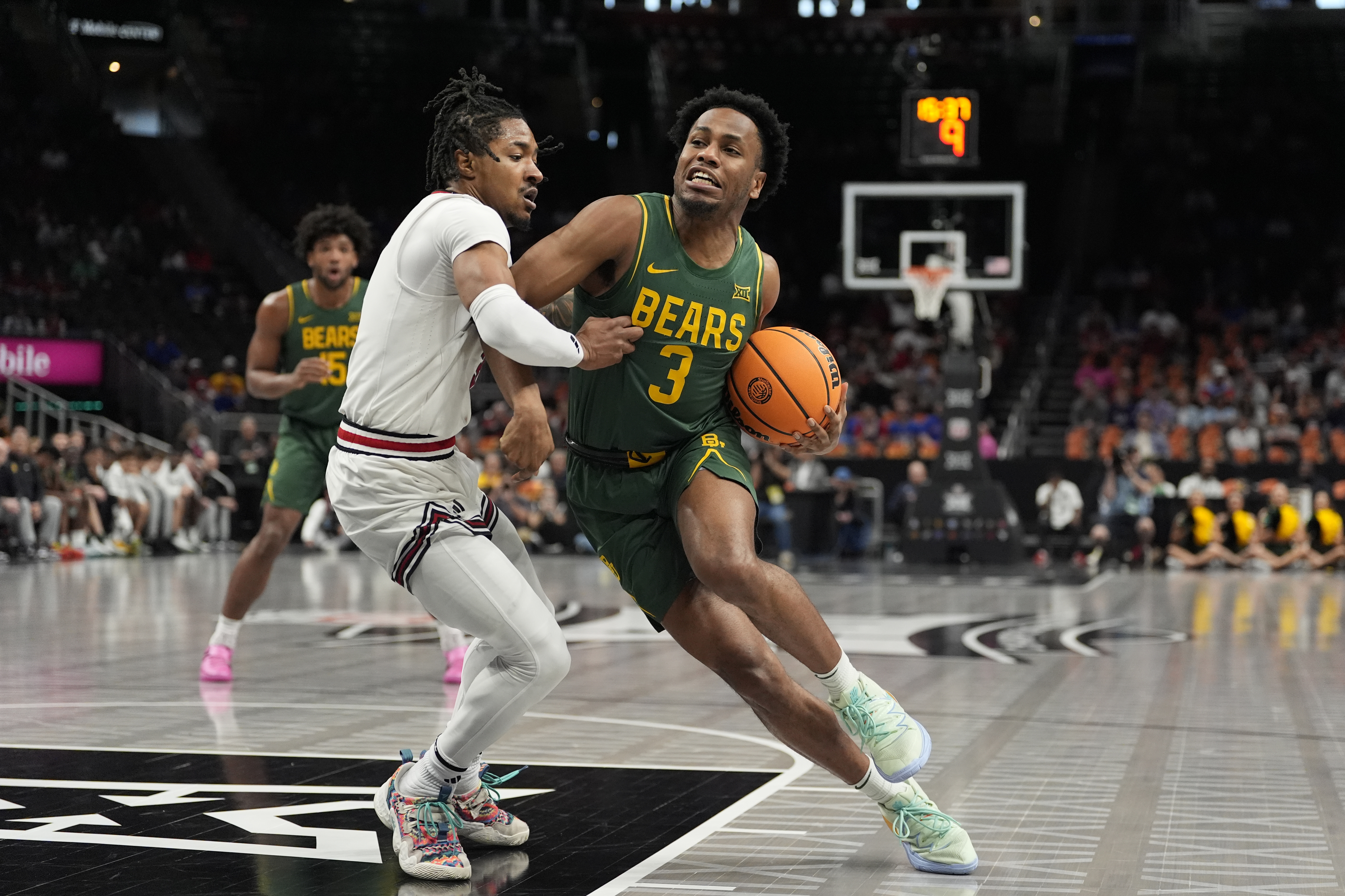 Baylor's Jeremy Roach, right, heads to the basket past Texas Tech's Elijah Hawkins during the first half of an NCAA college basketball game in the quarterfinal round of the Big 12 Conference tournament, Thursday, March 13, 2025, in Kansas City, Mo.