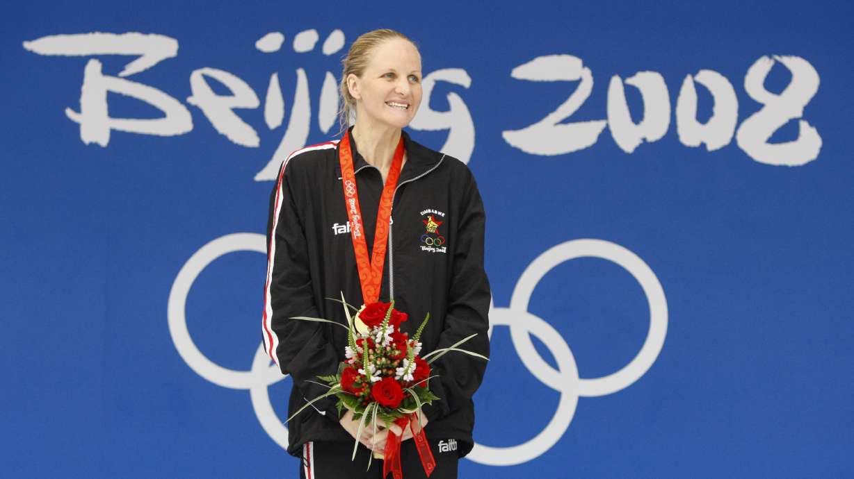 FILE - Zimbabwe's Kirsty Coventry smiles after receiving her gold medal after the women's 200-meter backstroke final during the swimming competitions in the National Aquatics Center at the Beijing 2008 Olympics in Beijing, Saturday, Aug. 16, 2008.