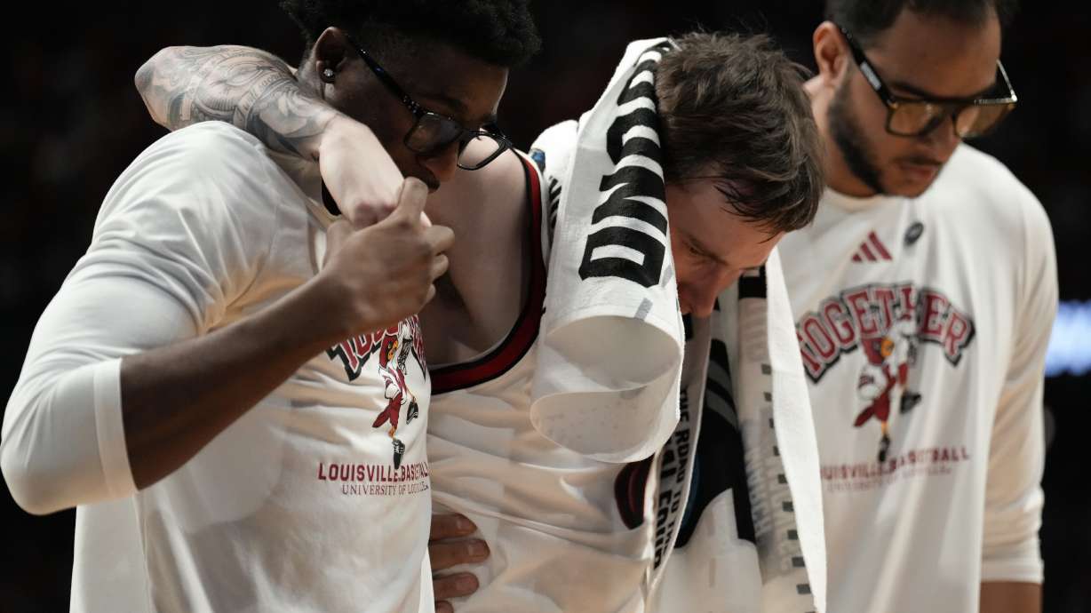 Louisville guard Reyne Smith (6) is helped off the court due to injury against Creighton during the second half in the first round of the NCAA college basketball tournament, Thursday, March 20, 2025, in Lexington, Ky.