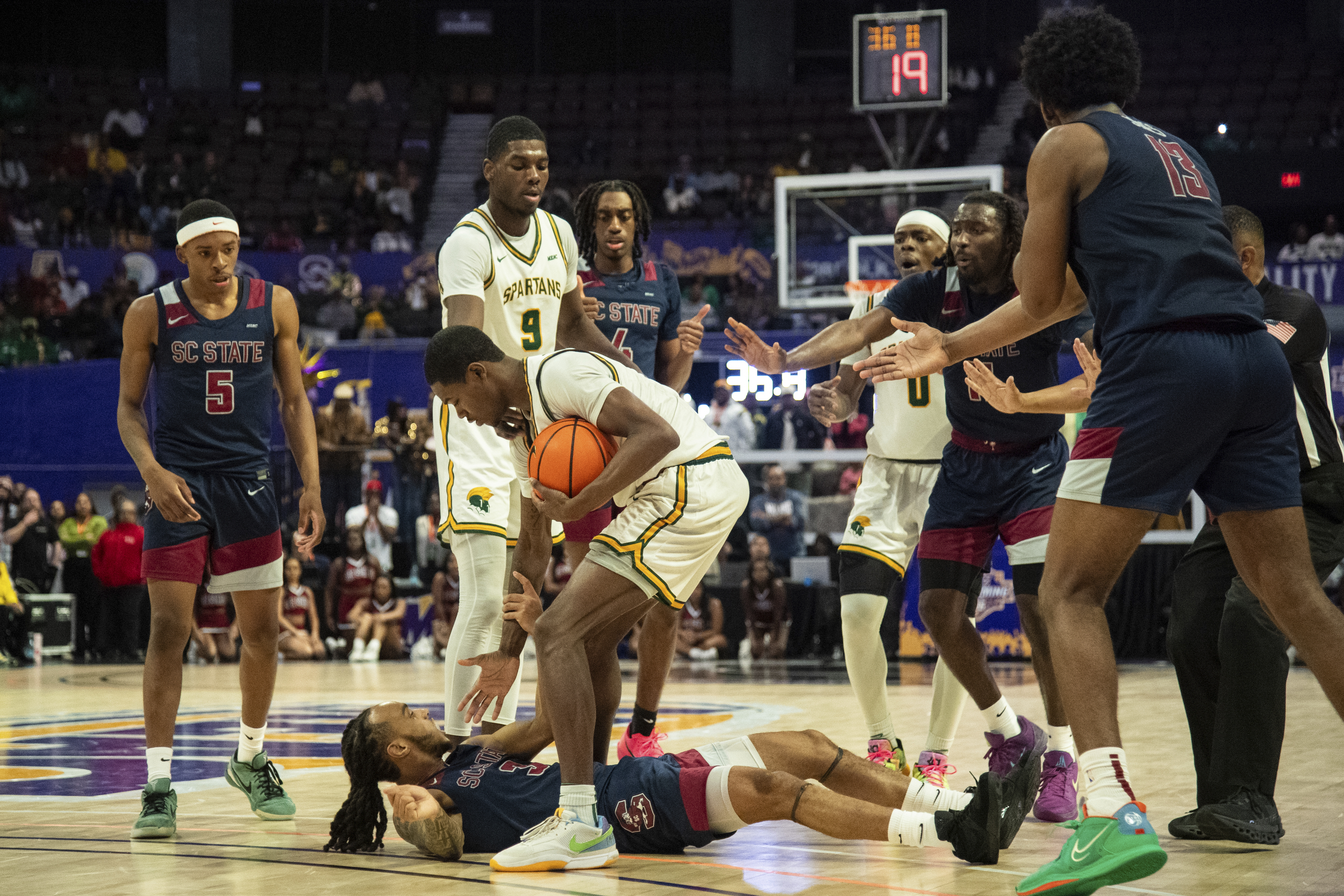 Norfolk State forward Jalen Myers (9) helps up South Carolina State guard Michael Teal (3) during the second half of an NCAA college basketball game in the championship of the Mid-Eastern Athletic Conference tournament, Saturday, March 15, 2025, in Norfolk, Va.