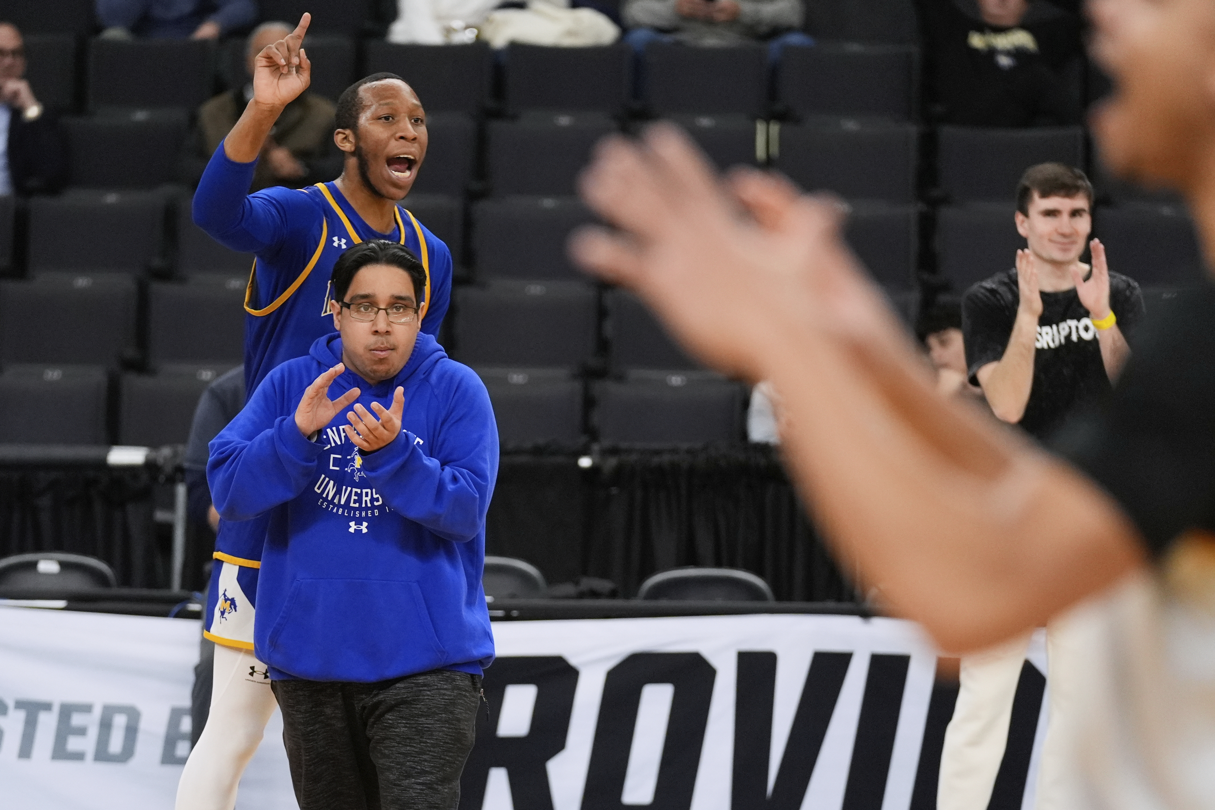 McNeese State men's basketball student manager Amir Khan, front left, applauds during the team's practice at the NCAA college basketball tournament, Wednesday, March 19, 2025, in Providence, R.I.
