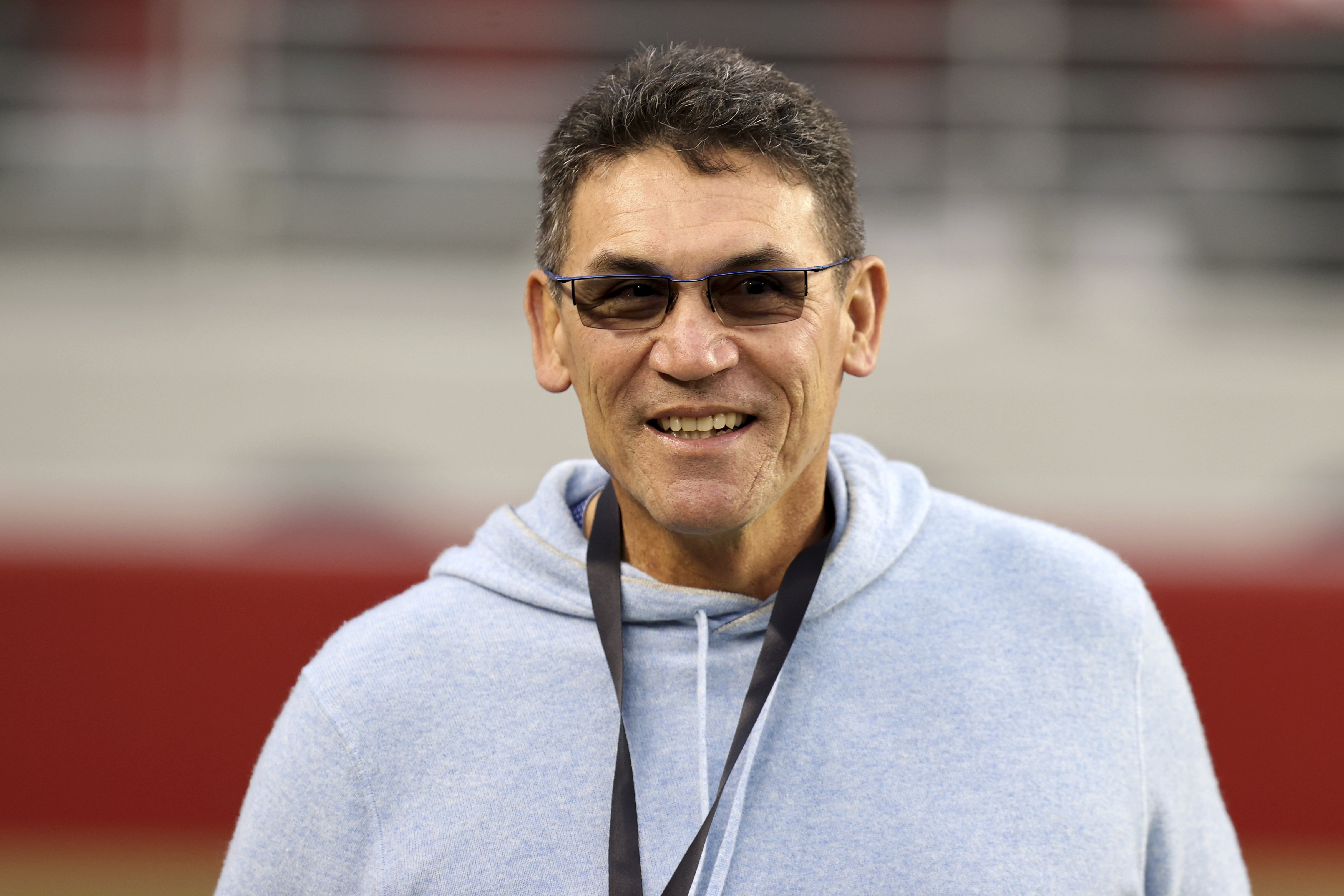 Former NFL player and coach Ron Rivera walks on the field before an NFL football game between the San Francisco 49ers and the Los Angeles Rams, Thursday, December 12, 2024, in Santa Clara, Calif.