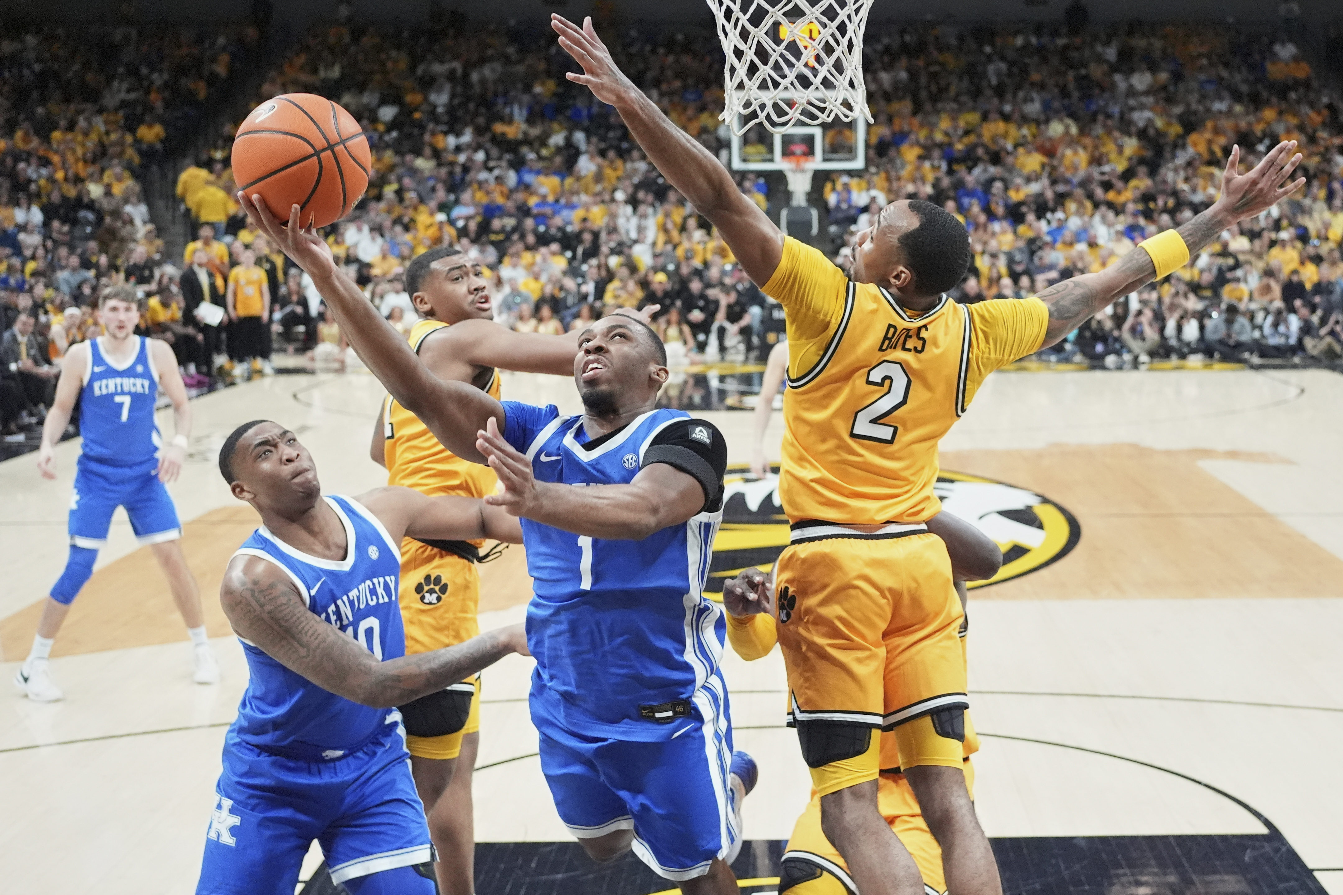 Kentucky's Lamont Butler (1) heads to the basket as teammate Brandon Garrison, left, watches as Missouri's Tamar Bates (2) defends during the second half of an NCAA college basketball game Saturday, March 8, 2025, in Columbia, Mo.