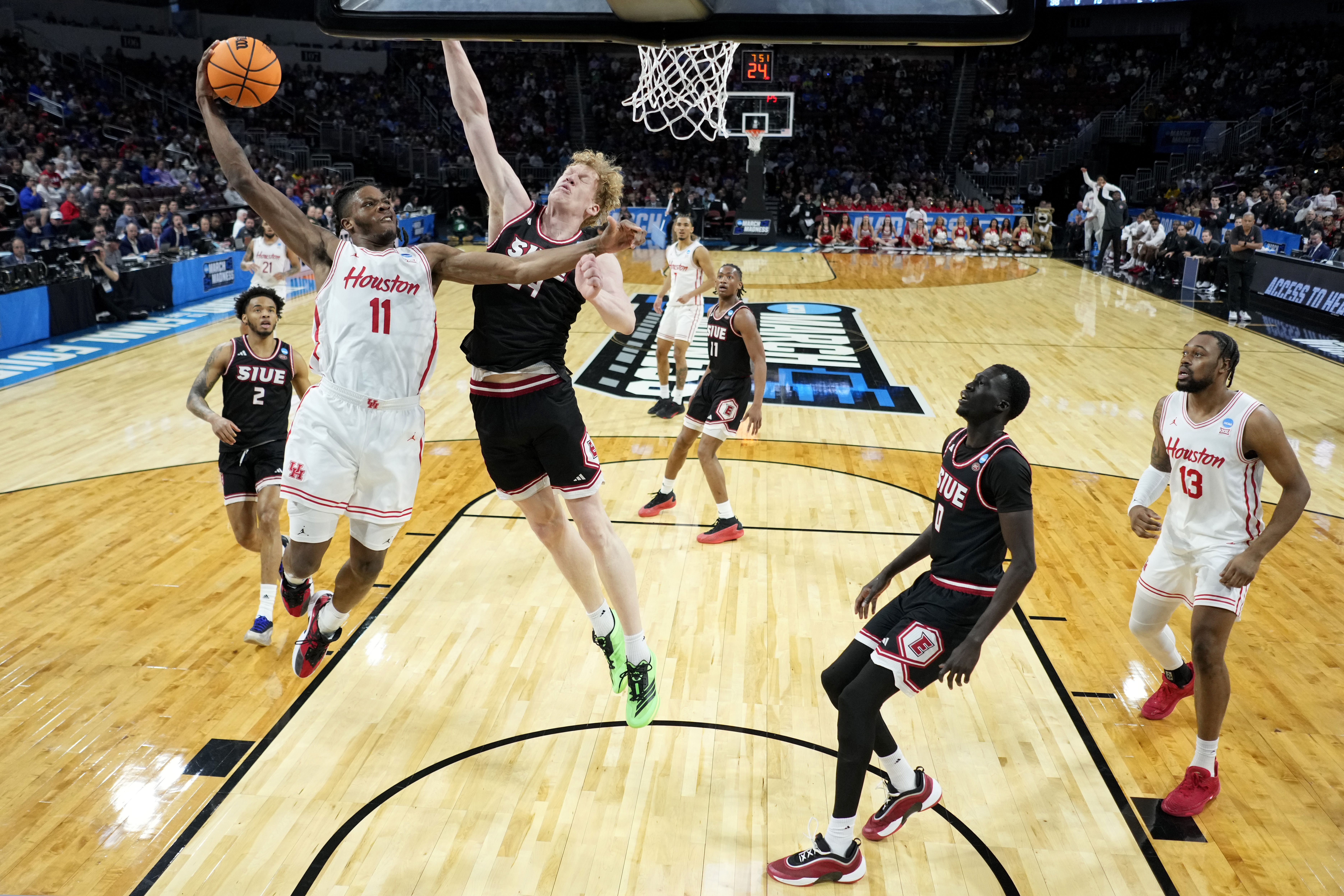 Houston forward Joseph Tugler (11) gets past SIU Edwardsville center Arnas Sakenis to put up a shot during the first half in the first round of the NCAA college basketball tournament, Thursday, March 20, 2025, in Wichita, Kan.