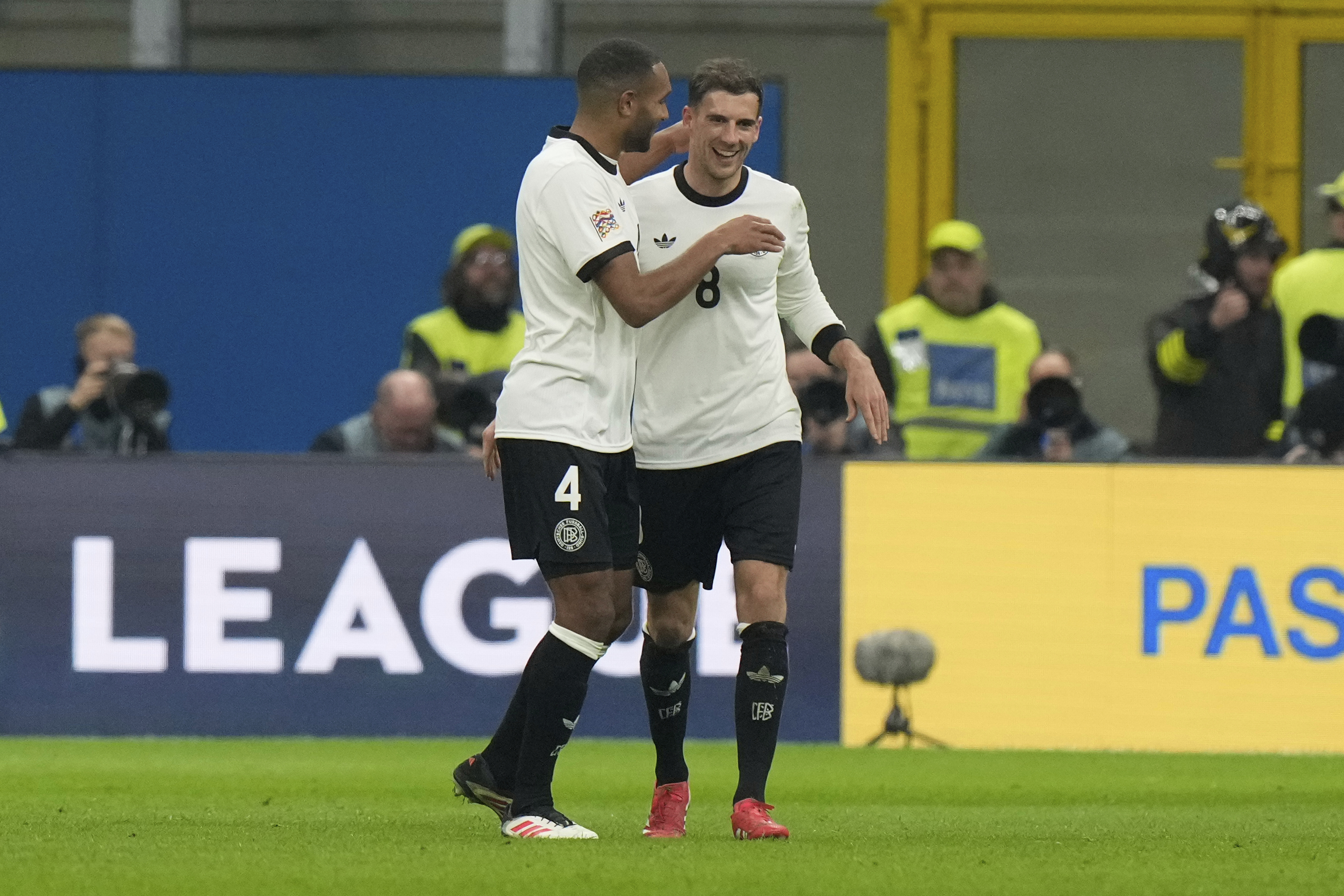 Germany's Leon Goretzka, right, celebrates after scoring his side's second goal during the soccer Nations League quarterfinal first leg soccer match between Italy and Germany, at the San Siro stadium in Milan, Italy, Thursday, March 20, 2025.