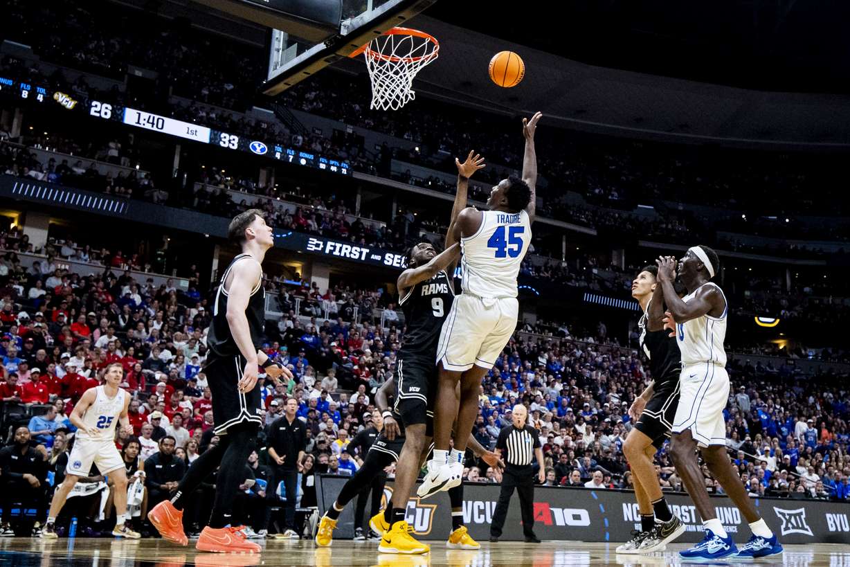 BYU Cougars center Fousseyni Traore (45) takes a hook shot while guarded by Virginia Commonwealth Rams forward Luke Bamgboye (9) during a first-round college basketball game in the NCAA Tournament held at Ball Arena in Denver, Colo., on Thursday, March 20, 2025.