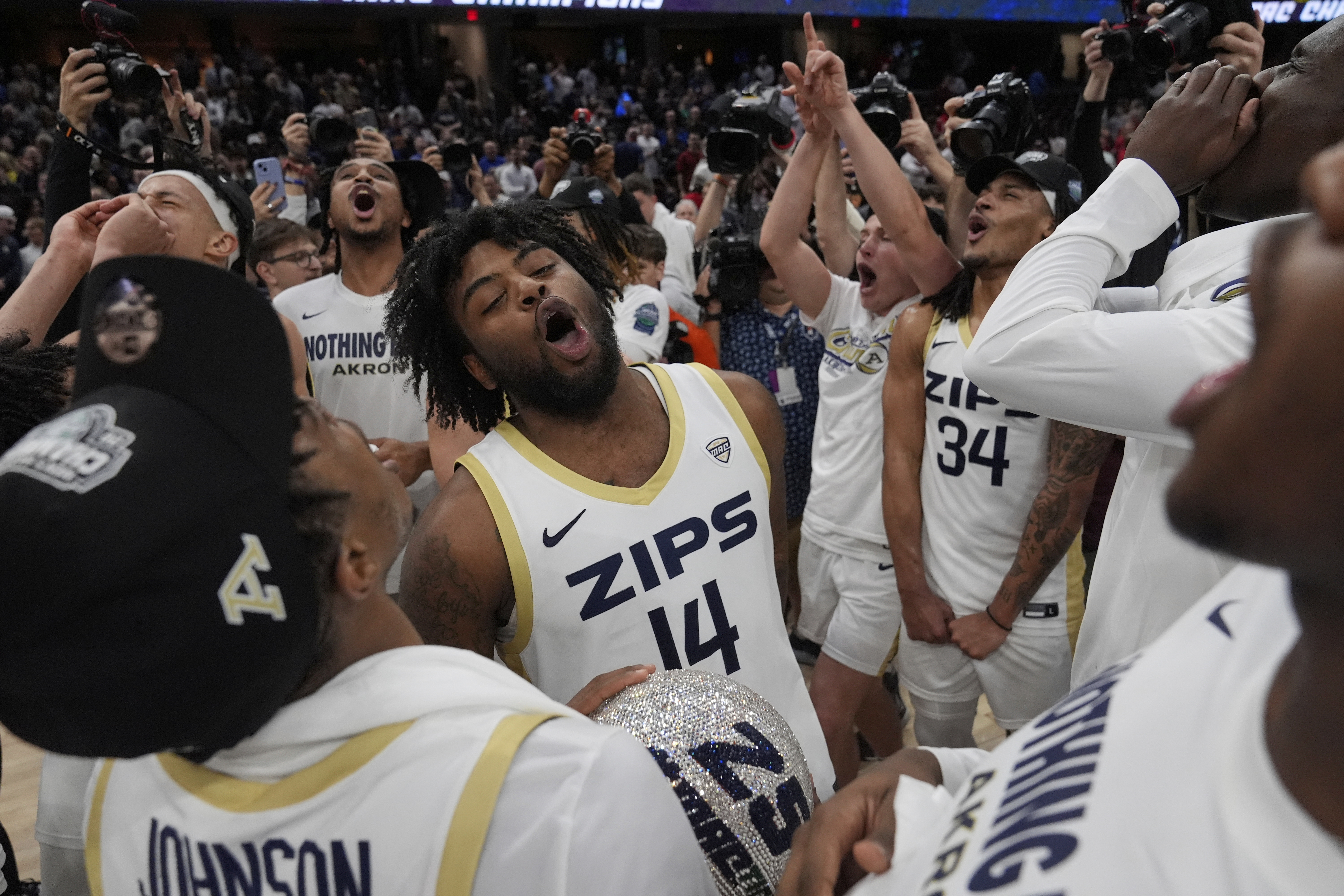 Akron guard Seth Wilson (14) and Nate Johnson (34) celebrate after Akron defeated Miami (Ohio) in an NCAA college basketball game in the championship of the Mid-American Conference tournament, Saturday, March 15, 2025, in Cleveland, Ohio. 