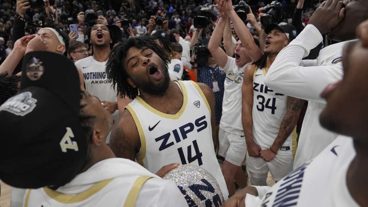 Akron guard Seth Wilson (14) and Nate Johnson (34) celebrate after Akron defeated Miami (Ohio) in an NCAA college basketball game in the championship of the Mid-American Conference tournament, Saturday, March 15, 2025, in Cleveland, Ohio.
