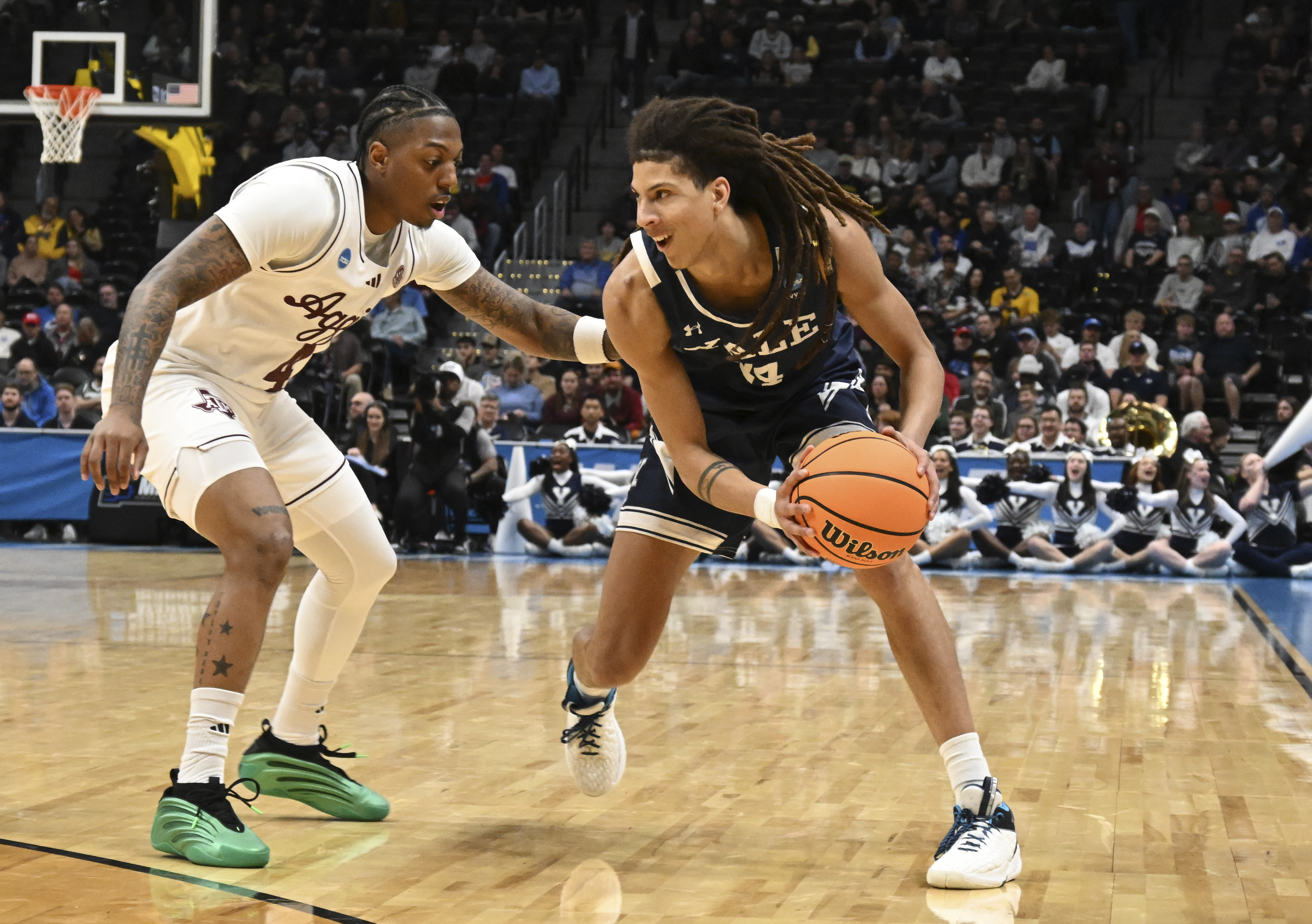 Yale forward Casey Simmons, right, drives to the basket as Texas A&M guard Wade Taylor IV, left, defends during the first half in the first round of the NCAA college basketball tournament Thursday, March 20, 2025, in Denver. 