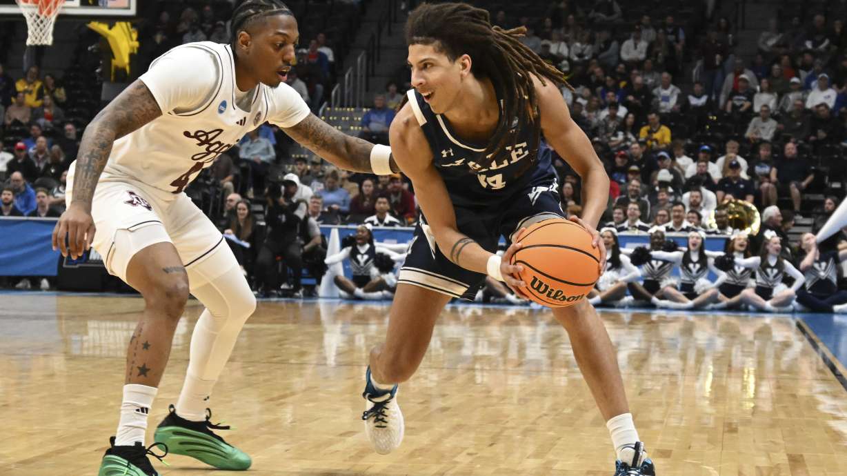 Yale forward Casey Simmons, right, drives to the basket as Texas A&M guard Wade Taylor IV, left, defends during the first half in the first round of the NCAA college basketball tournament Thursday, March 20, 2025, in Denver.