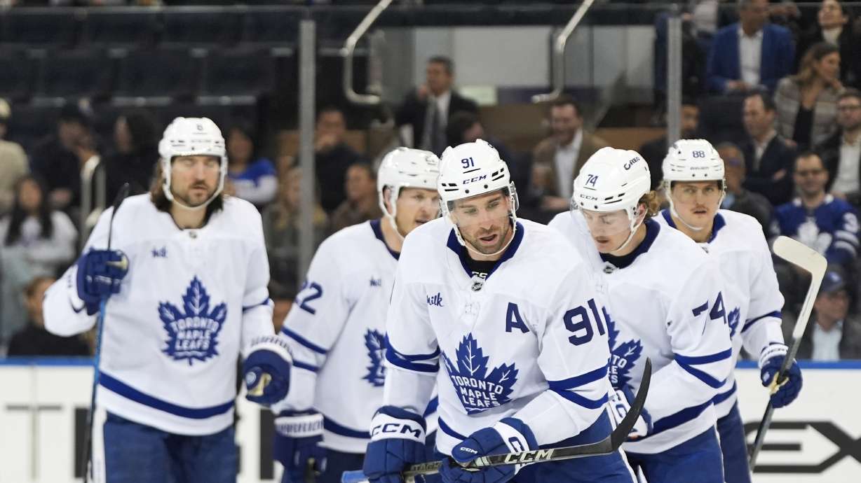 Toronto Maple Leafs defenseman Chris Tanev (8), defenseman Jake McCabe (22), right wing William Nylander (88), center Bobby McMann (74) and center John Tavares (91) skate toward the bench after Tavares scored during the second period of an NHL hockey game against the New York Rangers, Thursday, March 20, 2025, in New York.