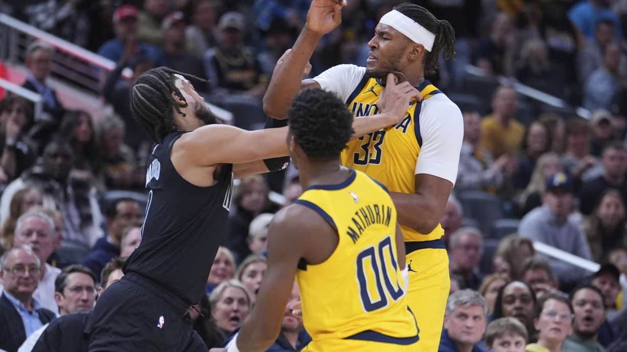 Brooklyn Nets forward Trendon Watford, left, Indiana Pacers center Myles Turner (33) and guard Bennedict Mathurin (00) scuffle during the second half of an NBA basketball game in Indianapolis, Thursday, March 20, 2025.