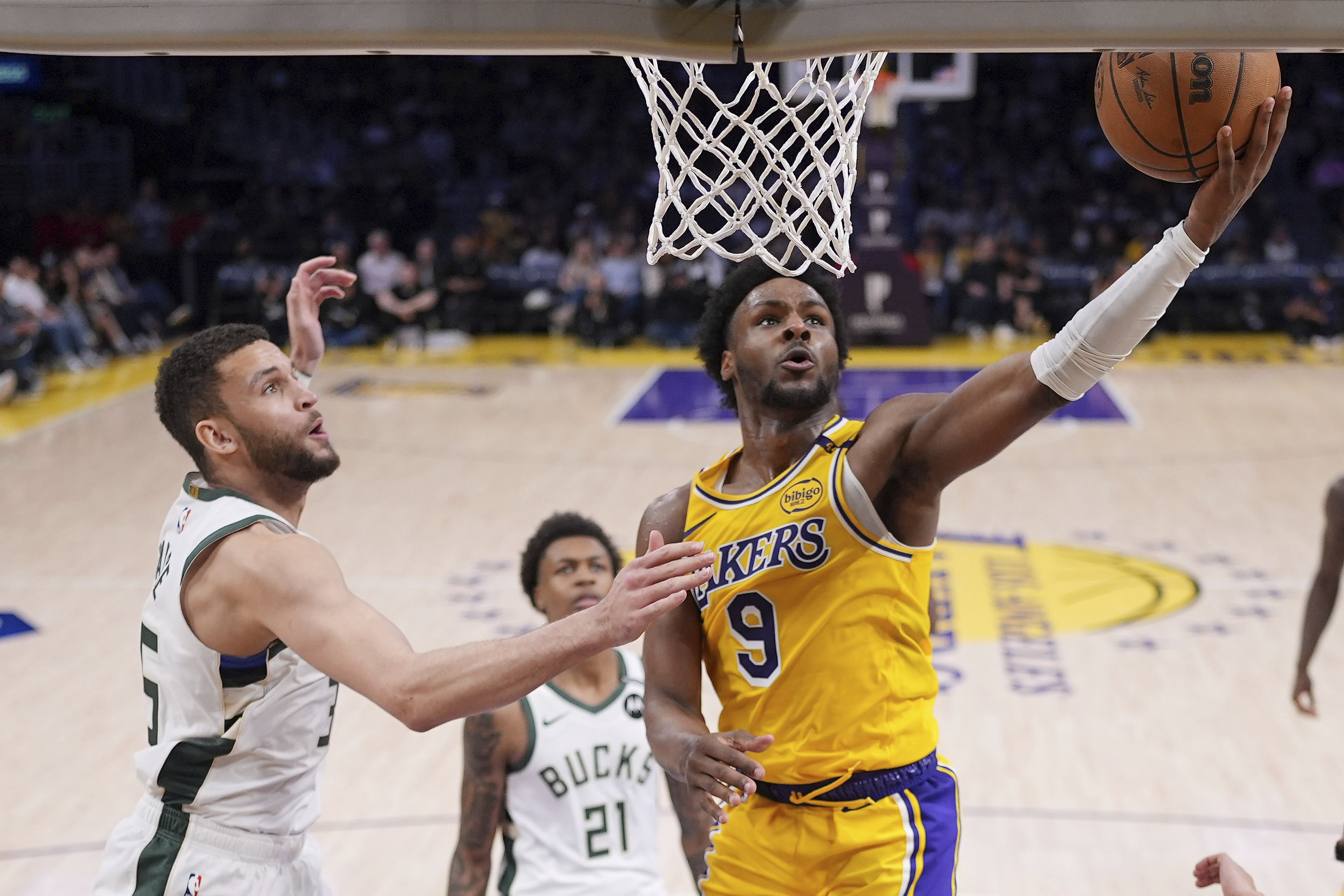 Los Angeles Lakers guard Bronny James, shoots as Milwaukee Bucks forward Pete Nance defends during the second half of an NBA basketball game Thursday, March 20, 2025, in Los Angeles.