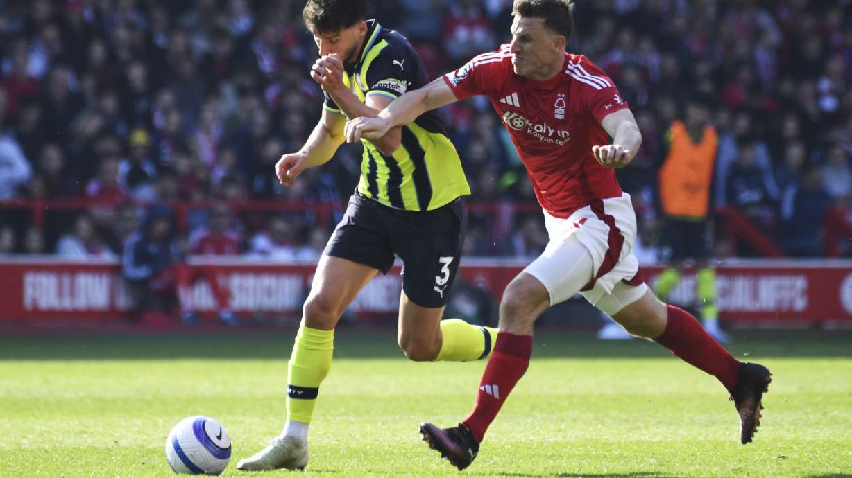 Nottingham Forest's Chris Wood, right, and Manchester City's Ruben Dias vie for the ball during the English Premier League soccer match between Nottingham Forest and Manchester City at the City Ground stadium, in Nottingham, England, Saturday, March 8, 2025.