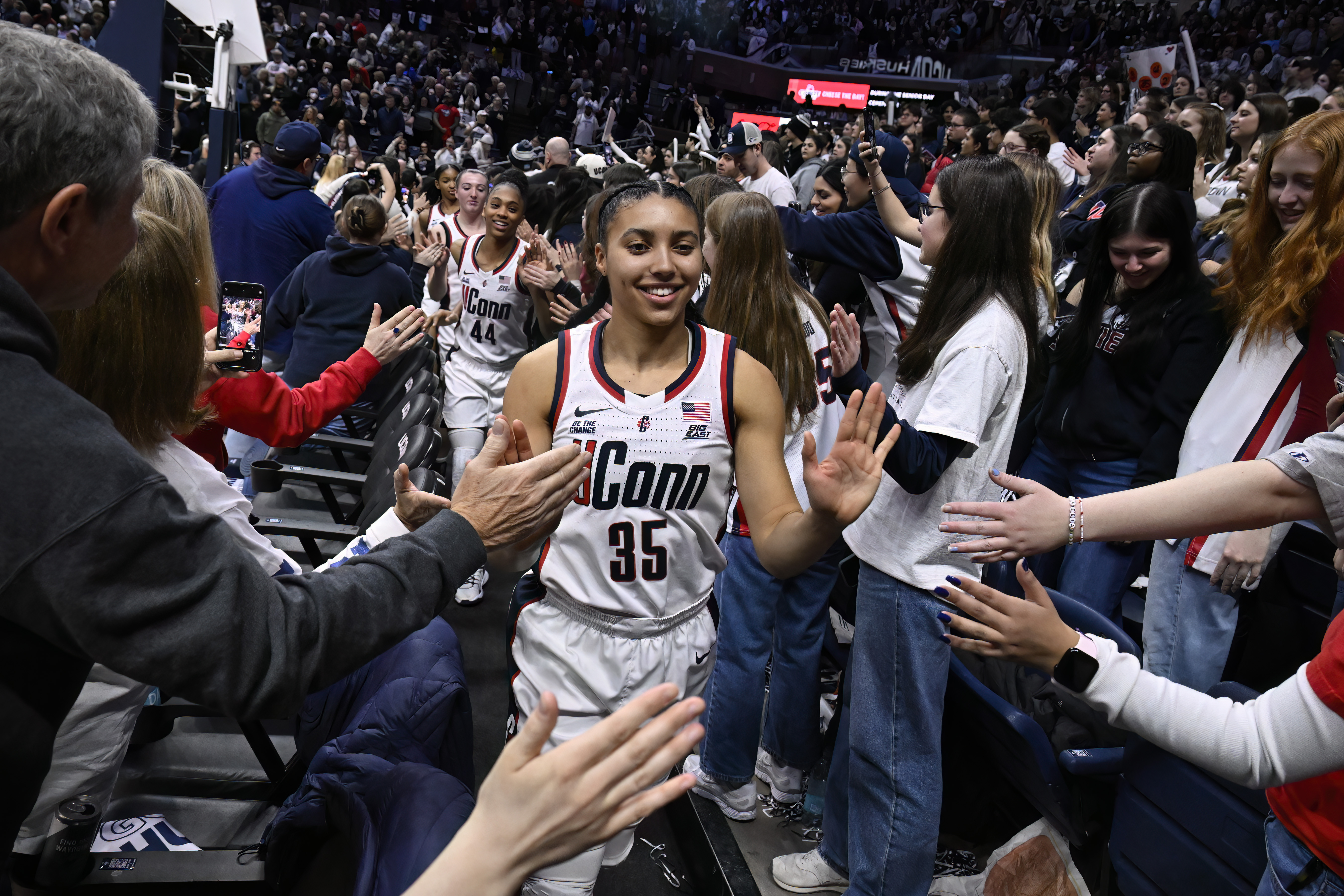 UConn guard Azzi Fudd (35) slaps hands with fans and the student section after an NCAA college basketball game against Marquette, Sunday, March 2, 2025, in Storrs, Conn.