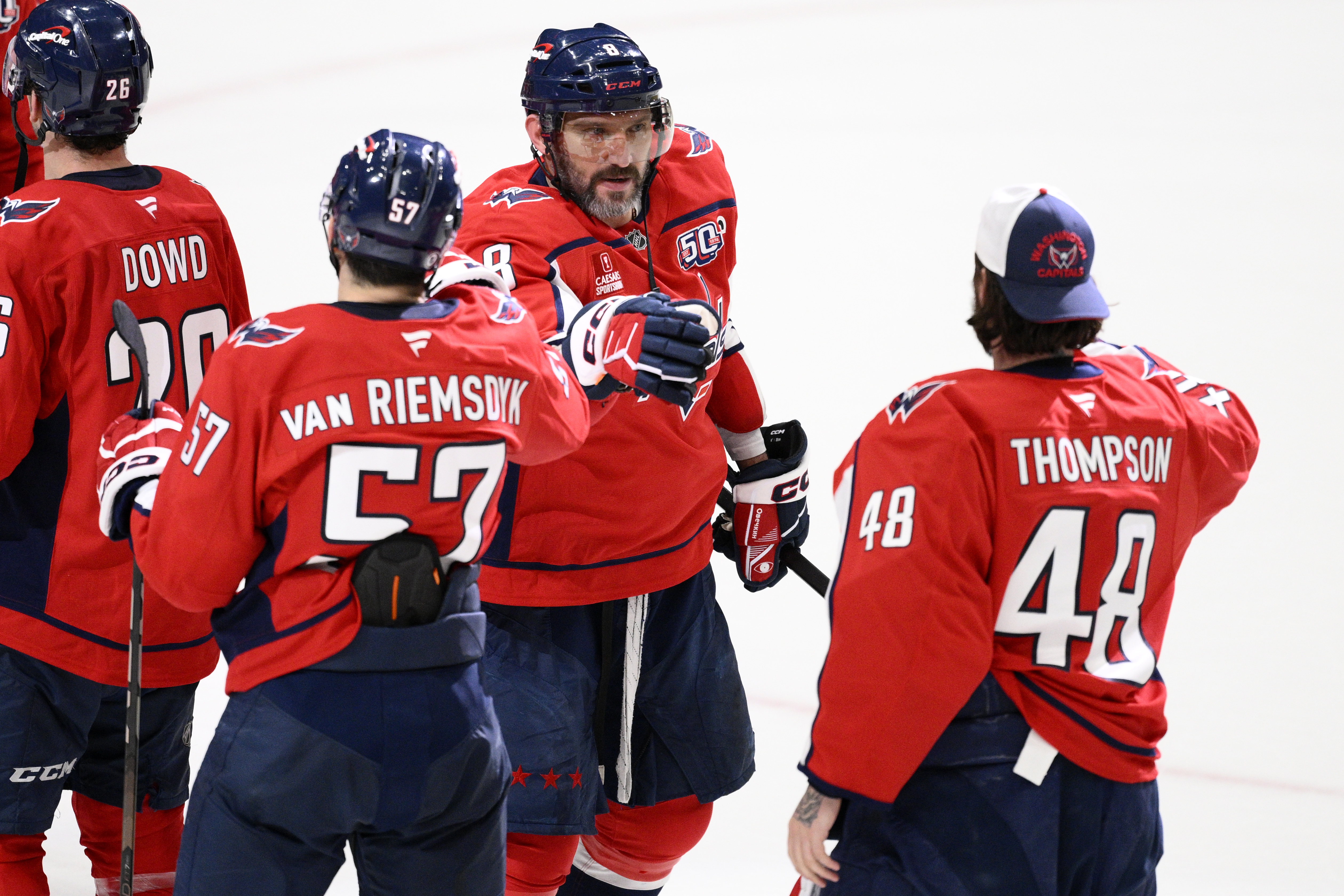 Washington Capitals left wing Alex Ovechkin (8) celebrates with defenseman Trevor van Riemsdyk (57) and goaltender Logan Thompson (48) after an NHL hockey game against the Philadelphia Flyers, Thursday, March 20, 2025, in Washington.