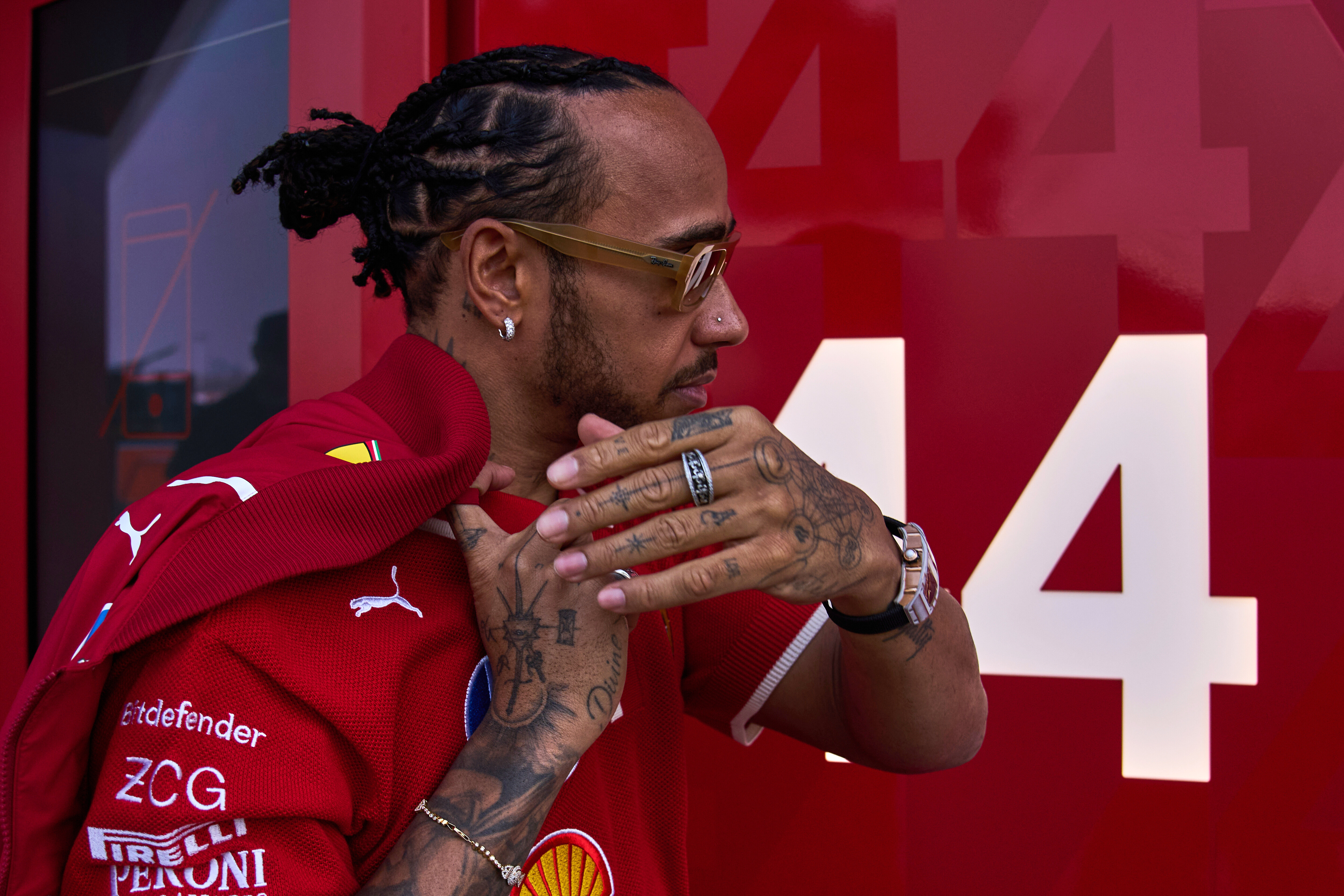 Ferrari driver Lewis Hamilton of Britain gestures as he arrives to his team garage at the Shanghai International Circuit ahead of the Chinese Formula One Grand Prix, in Shanghai, China, Thursday, March 20, 2025.
