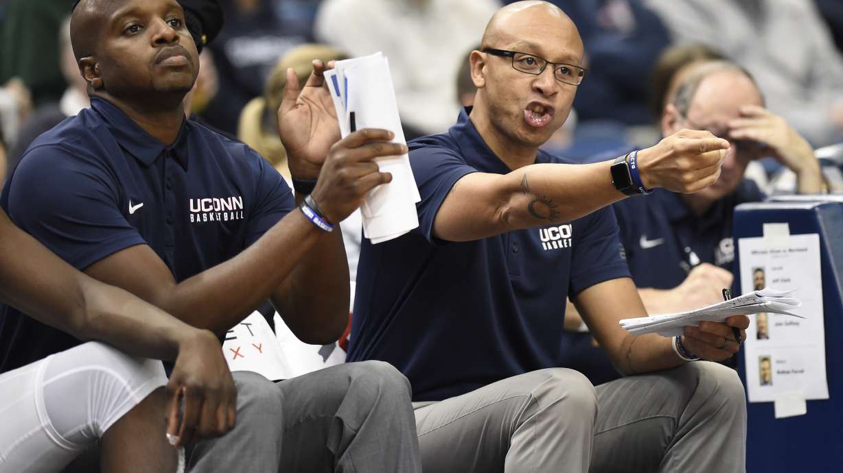 Associated head coach Raphael Chillious, right, and assistant coach Dwayne Killings during the first half of an NCAA college basketball game, Monday, Oct. 30, 2017, in Hartford, Conn.