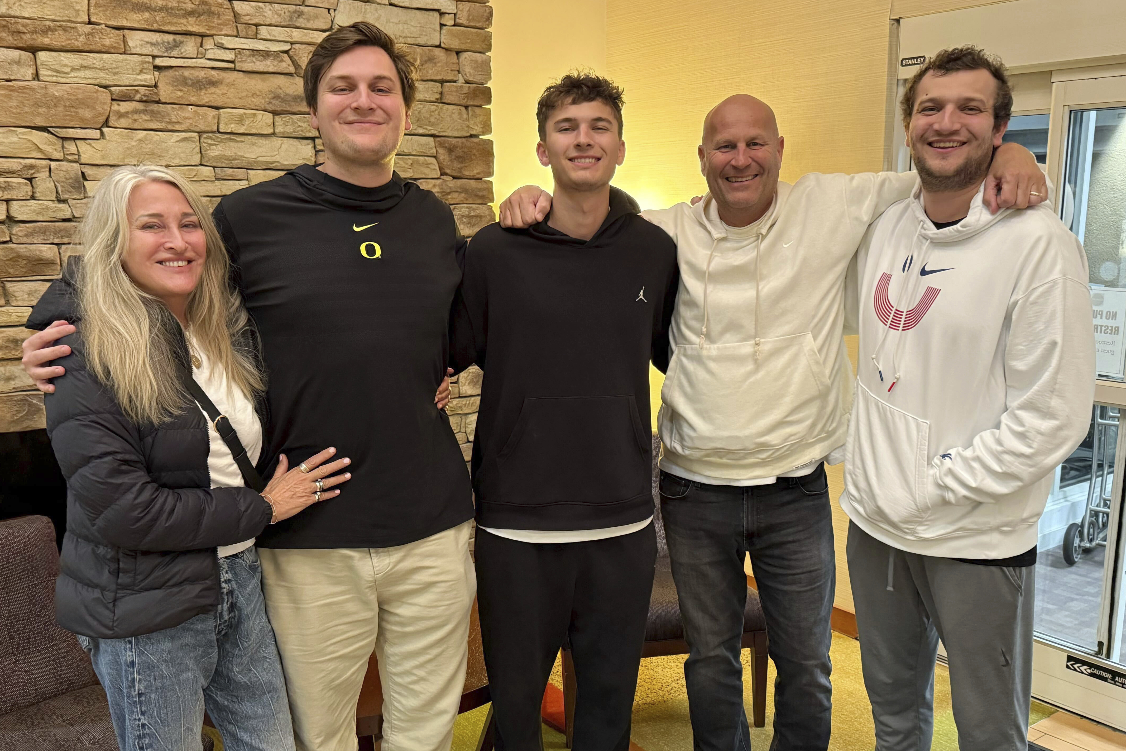 In this image provided by courtesy of Kelly Graves, Oregon men's basketball coach Kelly Graves, second from right, poses with his family, from left, wife Mary, sons Jack, Will, graduate assistant at Florida on the men's basketball team, and Max at a hotel in Raleigh, N.C., Thursday, March 20,2025. Both the Ducks and Gators are in the area to play in the NCAA college basketball tournament Friday.