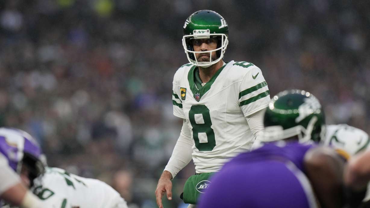 FILE - New York Jets quarterback Aaron Rodgers (8) looks out over the line of scrimmage during an NFL football game against the Minnesota Vikings at Tottenham Hotspur Stadium, Oct. 6, 2024 in London.