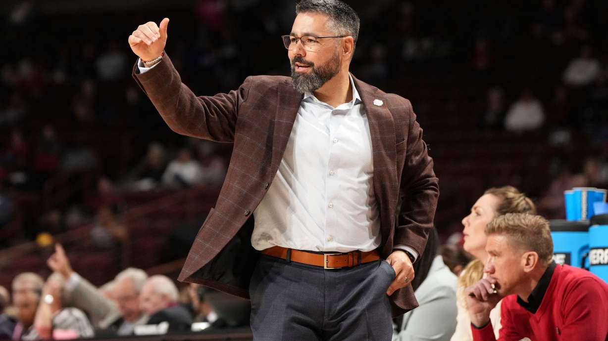 Utah head coach Gavin Petersen motions to a player during the first half against Indiana in the first round of the NCAA college basketball tournament, Friday, March 21, 2025, in Columbia, S.C.