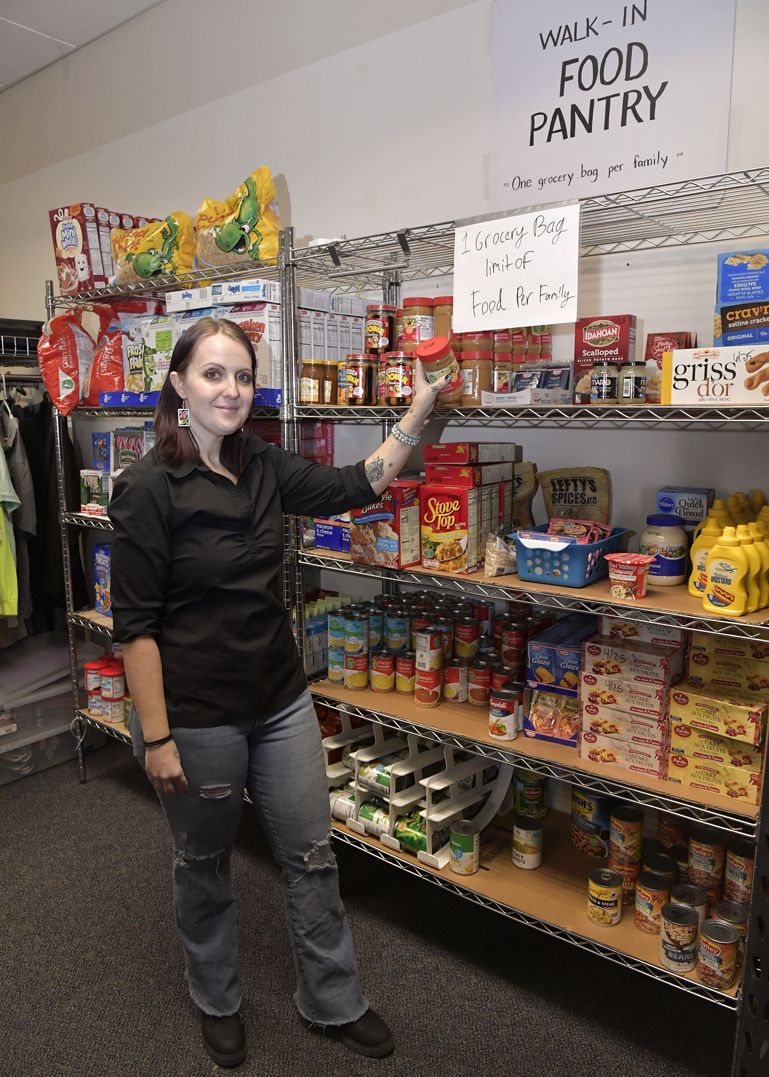 Sharaya Woodwick, Hill Air Force Base Airman’s Attic volunteer manager, stands by one of the two available food pantries on base in Clearfield on Feb. 25.