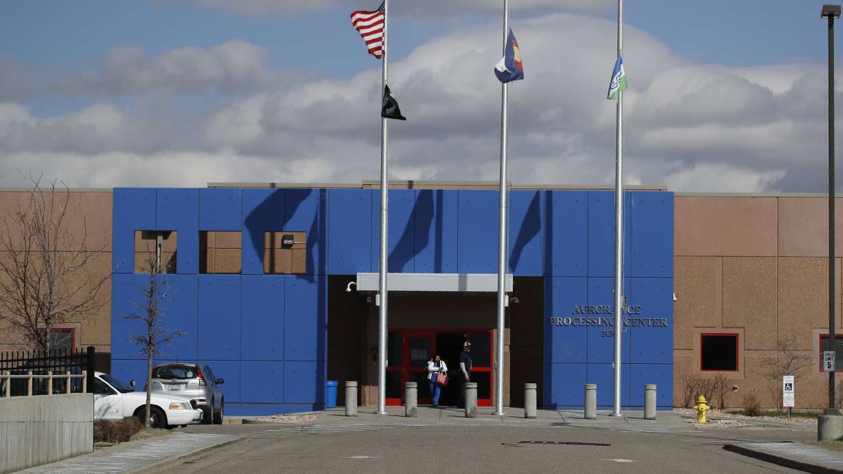 Visitors walk out of the GEO Detention Center, April 3, 2020, in Aurora, Colo. One of two men who escaped from a Colorado immigration detention center has been arrested after being found by a sheriff's deputy about 12 miles away.