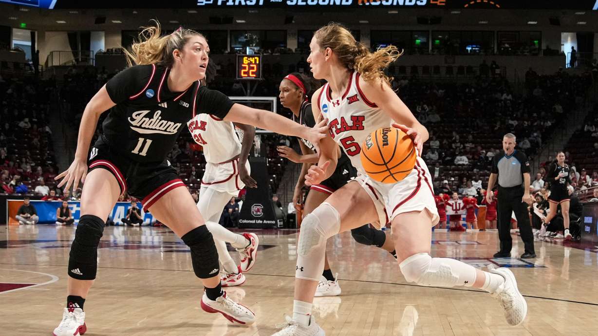 Utah guard Gianna Kneepkens (5) drives as Indiana forward Karoline Striplin (11) defends abasing during the second half in the first round of the NCAA college basketball tournament, Friday, March 21, 2025, in Columbia, S.C.