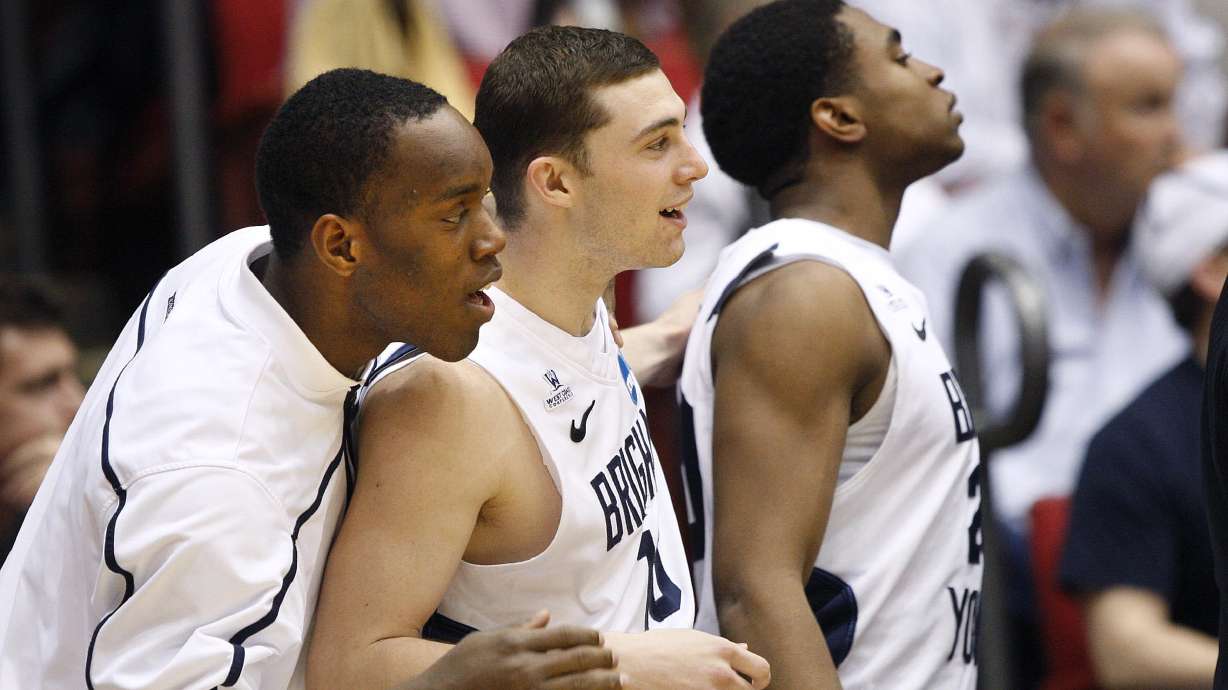 BYU's Charles Abouo (1), Matt Carlino and BYU's Anson Winder (20) watch in the second half if they are going to pull ahead late in the second half. of the BYU vs. Iona game, in round 1 of the NCAA Basketball Tournament, Tuesday, March 13, 2012 at the University of Dayton Arena in Dayton, Ohio. BYU won 78 to 72 and came back from being down 25 points at one time.