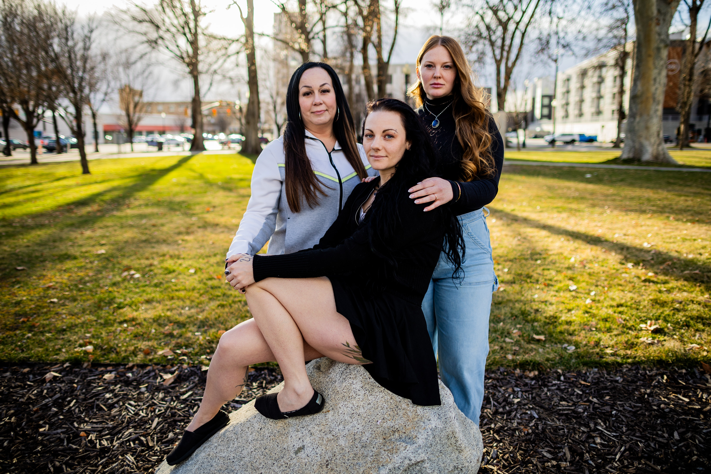 Elisha Paiz, a woman who wishes to remain anonymous, and Celeste Myers, from left, pose at Pioneer Park in Salt Lake City on March 2.