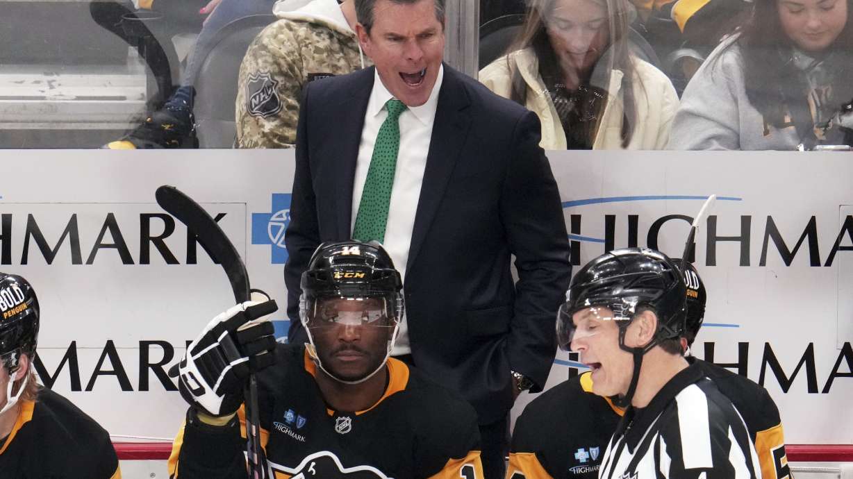 Pittsburgh Penguins head coach Mike Sullivan disagrees with a high sticking call by referee Wes McCauley (4) during the third period of an NHL hockey game against the New Jersey Devils in Pittsburgh, Saturday, March 15, 2025.