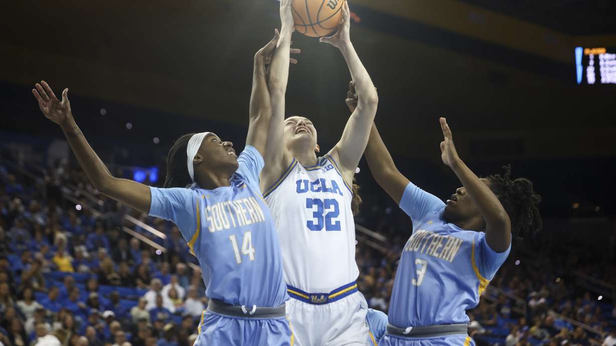 UCLA forward Angela Dugalic (32), Southern guard Soniyah Reed (14) and Southern guard Taniya Lawson (3) reach for a rebound during the first half in the first round of the NCAA college basketball tournament Friday, March 21, 2025, in Los Angeles.