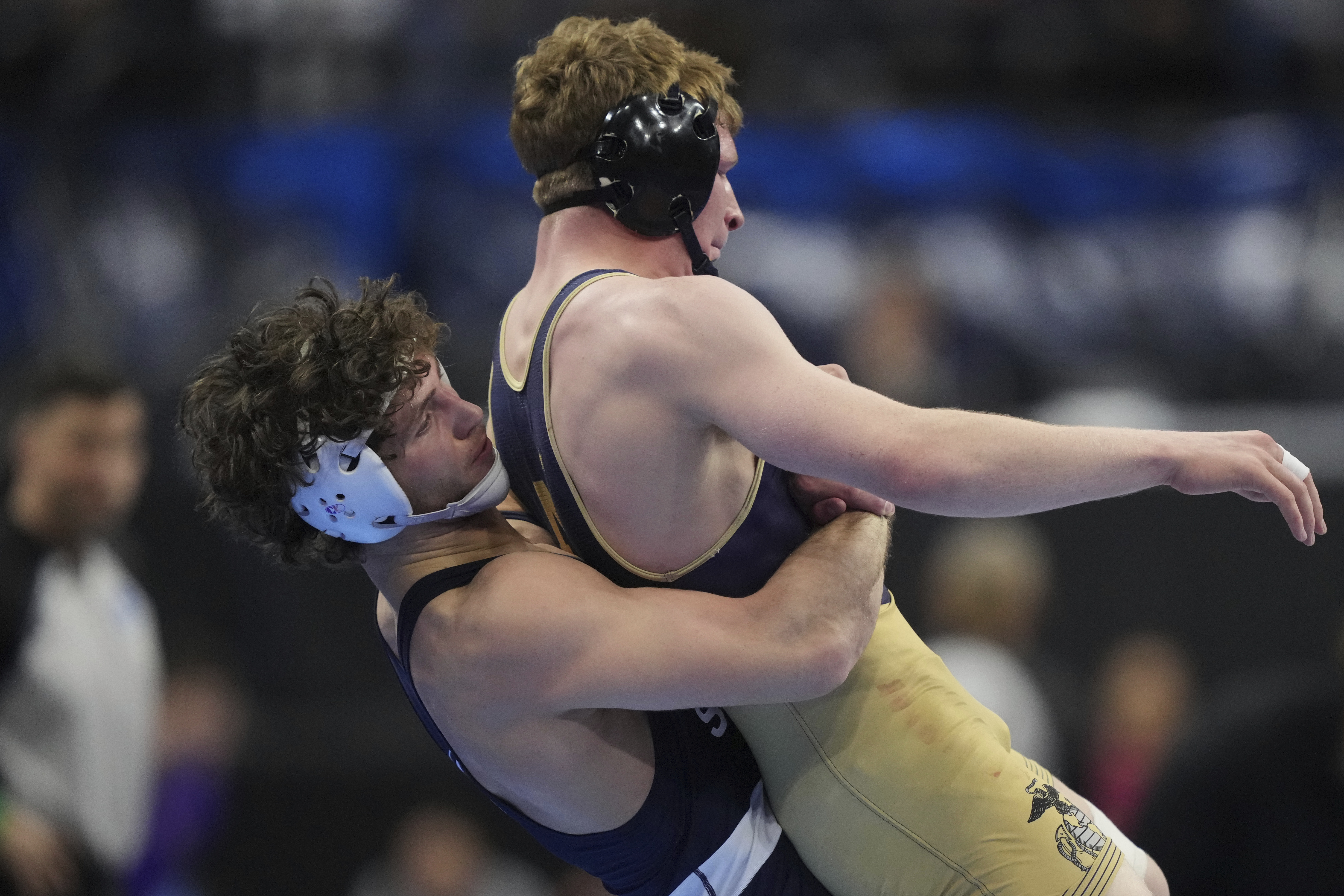 Penn State's Levi Haines, left, takes on Navy's Danny Wask in their 174-pound quarter finals match during the NCAA wrestling championships, Friday, March 21, 2025, in Philadelphia.