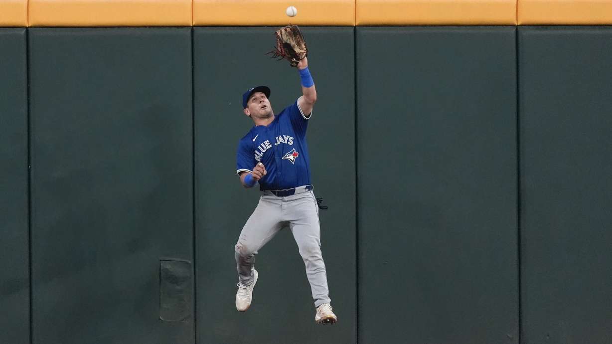 FILE - Toronto Blue Jays center fielder Daulton Varsho catches a fly ball off the bat of Atlanta Braves' Michael Harris II in the fourth inning of a baseball game on Sept. 6, 2024, in Atlanta.