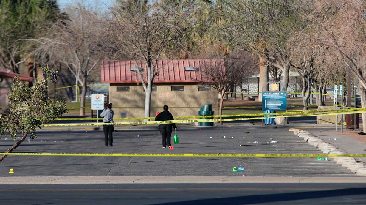 Crime scene technicians look over the Young Park parking lot after a mass shooting overnight, Saturday in Las Cruces, N.M.