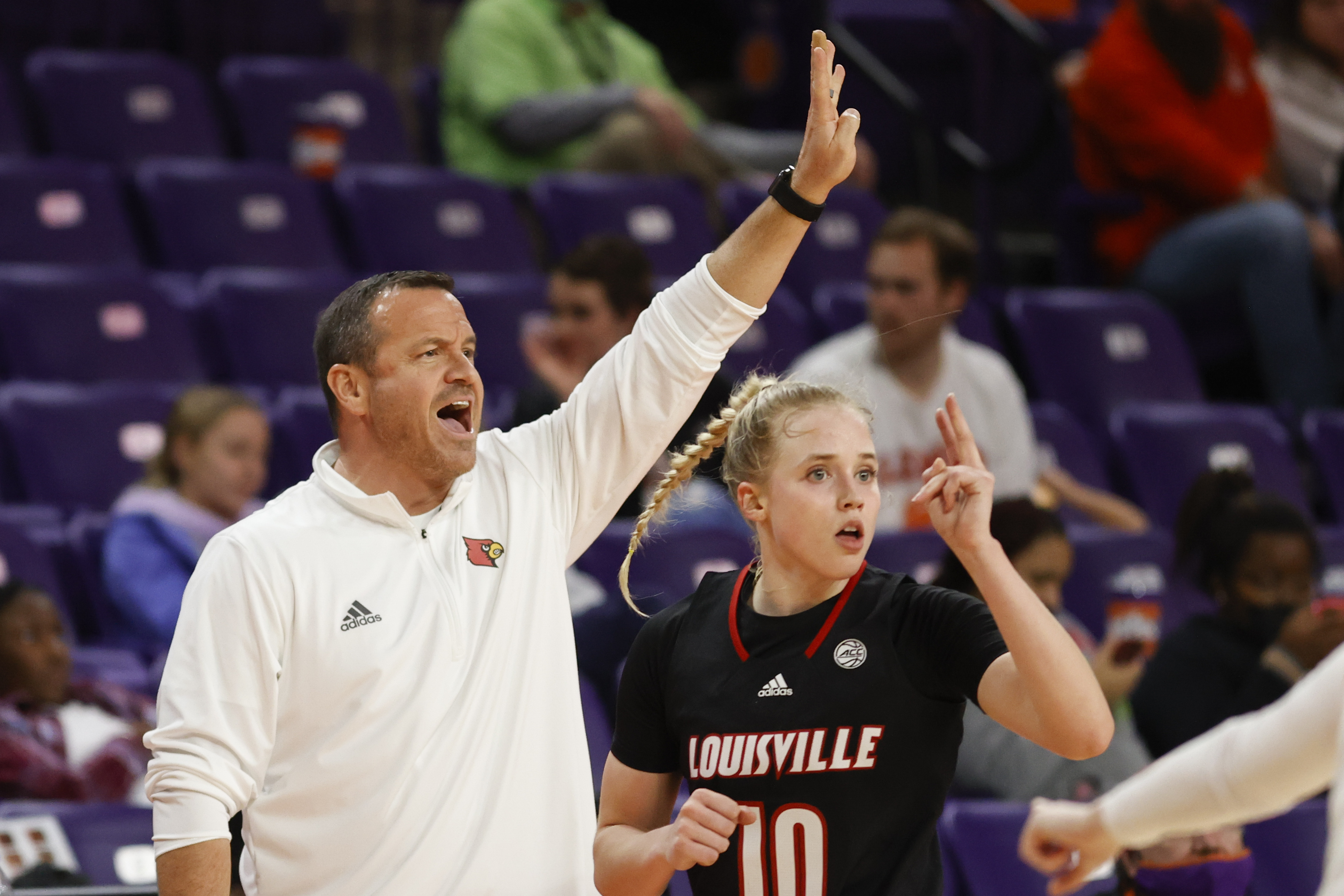 FILE - Louisville head coach Jeff Walz, left, and guard Hailey Van Lith direct their team against Clemson in the third quarter of an NCAA college basketball game in Clemson, S.C., Thursday, Feb. 3, 2022.