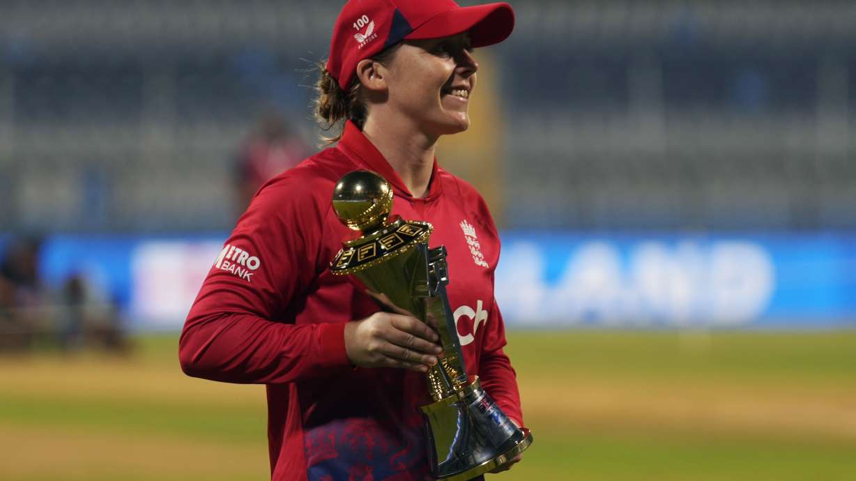 FILE - England's captain Heather Knight holds the trophy after England won the three-match T20 women's cricket series against India in Mumbai, India, Sunday, Dec. 10, 2023.