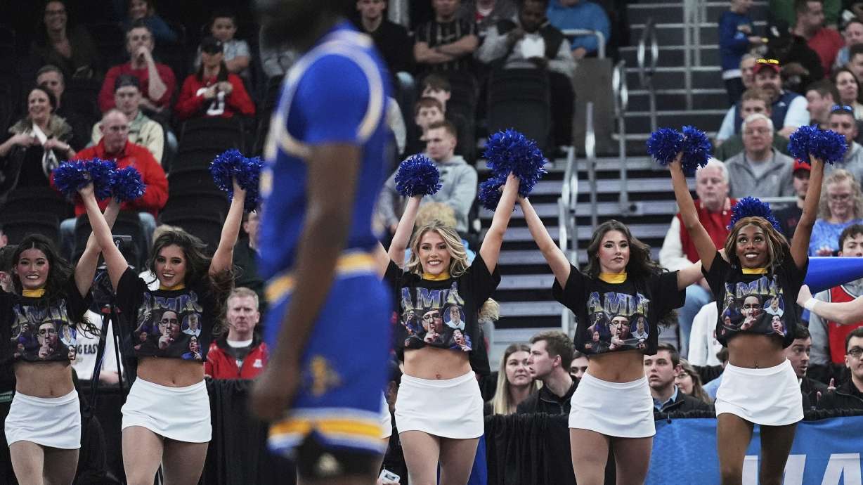 McNeese State cheerleaders wear t-shirts highlighting team student manager Amir Kahn during the first half in the second round of the NCAA college basketball tournament, Saturday, March 22, 2025, in Providence, R.I.
