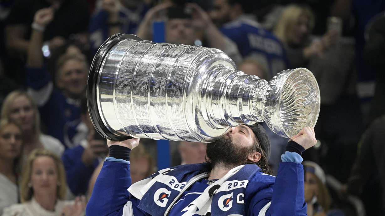 FILE - Tampa Bay Lightning left wing Pat Maroon kisses the Stanley Cup after getting the win over the Montreal Canadiens in Game 5 of the NHL hockey Stanley Cup finals series, Wednesday, July 7, 2021, in Tampa, Fla.