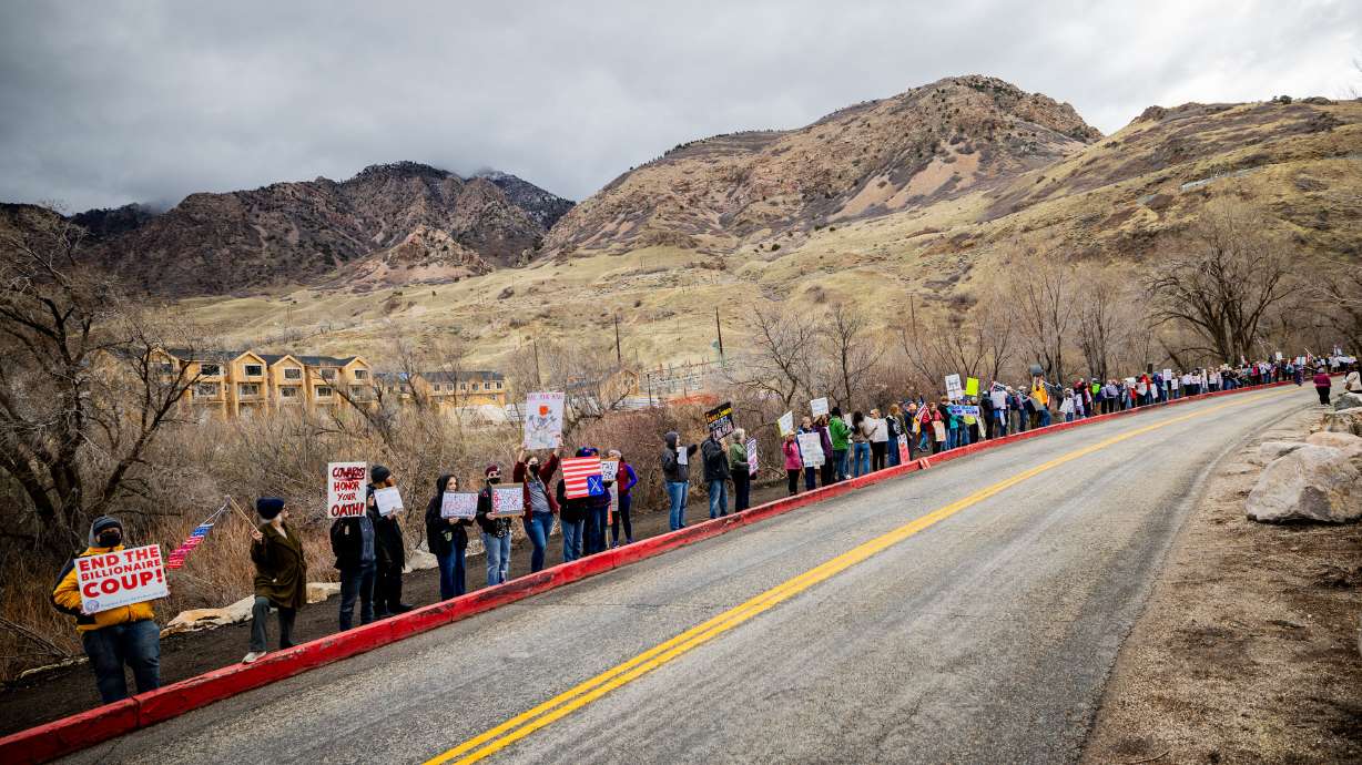 People protest outside Congressman and Doge co-chair Blake Moore's GOP Luncheon at Timbermine Steakhouse in Ogden on Saturday.