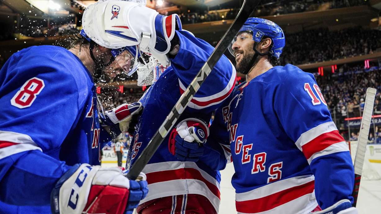 New York Rangers left wing J.T. Miller (8), celebrates with goaltender Igor Shesterkin, center, and center Vincent Trocheck, right, after scoring a goal during the third period of an NHL hockey game against the Vancouver Canucks, Saturday, March 22, 2025, in New York.