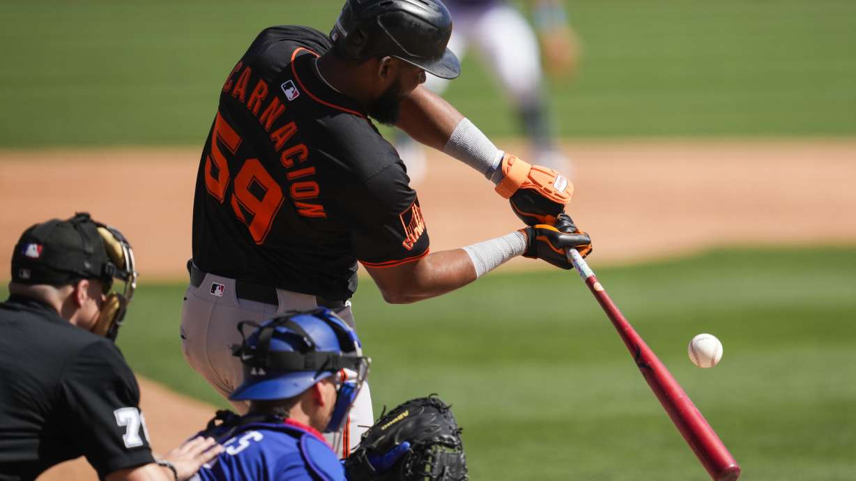 San Francisco Giants designated hitter Jerar Encarnacion swings a strike during the third inning of a spring training baseball game against the Los Angeles Dodgers, Saturday, March 1, 2025, in Phoenix.