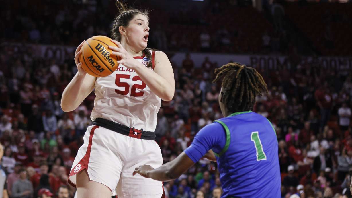 Oklahoma center Raegan Beers (52) grabs a rebound near Florida Gulf Coast guard Emani Jefferson (1) during the first half in the first round of the NCAA college basketball tournament, Saturday, March 22, 2025, in Norman, Okla.